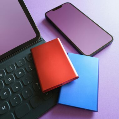 Colorful gadgets including a smartphone, tablet, and SSD on a purple background, ideal for tech-themed projects.